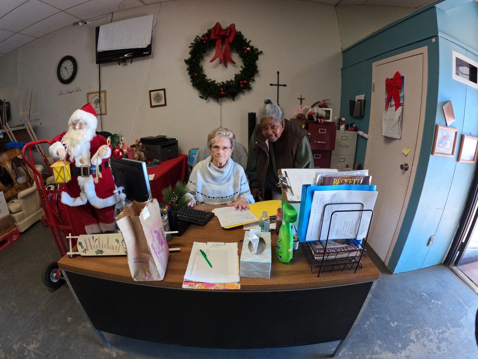 Two volunteers behind the front desk of the pantry