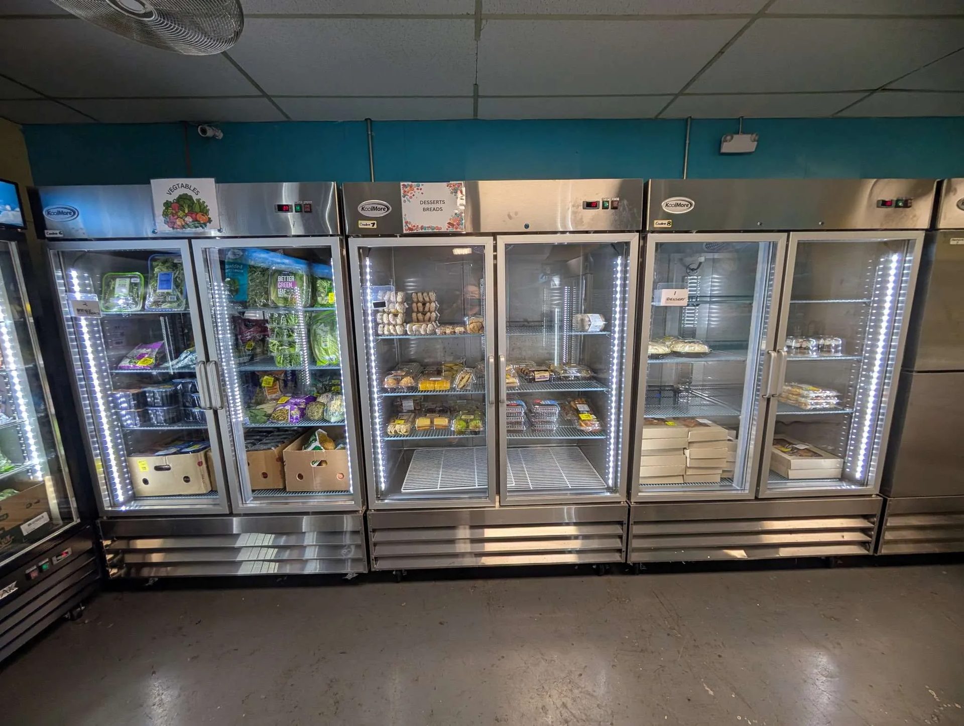 Coolers of vegetables, desserts and breads in the pantry